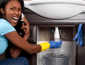 Emergency plumbing repair for a leaking sink drain under a bathroom vanity in Ogden, UT