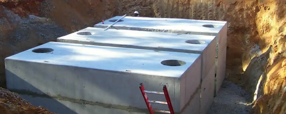 Septic tank installation site with a newly placed concrete tank in Ogden, UT